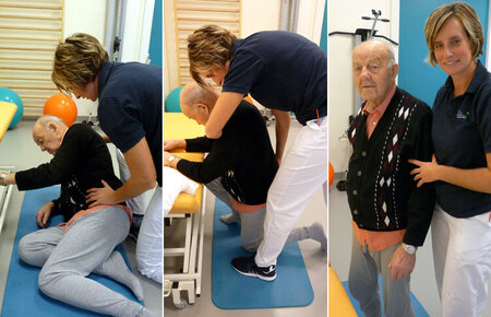 Physiotherapeutin trainiert mit einem am Boden liegenden Patienten das selbständige Aufstehen