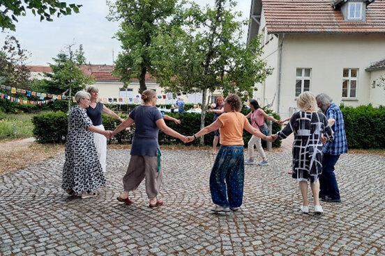 Menschen tanzen im Kreis